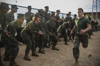 Marines with Marine Air Control Squadron 1 cheer on a fellow Marine during the o-course relay as part of the "Super Squadron" competition at the Memorial Sports Complex aboard Marine Corps Air Station Yuma, Ariz., Friday, Jan. 13, 2017. 