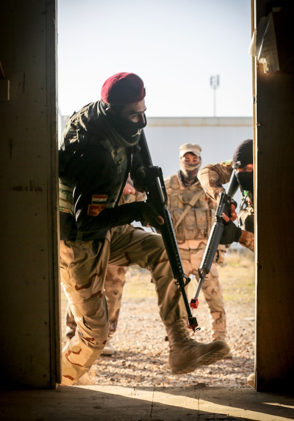 Iraqi soldiers from 7th Iraqi Army Division assault through a door during assault movement training at Al Asad Air Base, Iraq,  Jan. 13, 2017. Training at building partner capacity sites is an integral part of Combined Joint Task Force – Operation Inherent Resolve’s effort to train Iraqi security forces personnel to defeat ISIL. CJTF-OIR is the global Coalition to defeat ISIL in Iraq and Syria. (U.S. Army photo by Sgt. Lisa Soy)