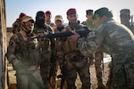 A British trainer, from 4th Battalion, “The Rifles,” shows Iraqi soldiers from 7th Iraqi Army Division how to hold a rifle during assault movement training at Al Asad Air Base, Iraq, Jan. 13, 2017. Training at building partner capacity sites is an integral part of Combined Joint Task Force – Operation Inherent Resolve’s effort to train Iraqi security forces personnel to defeat ISIL. CJTF-OIR is the global Coalition to defeat ISIL in Iraq and Syria. (U.S. Army photo by Sgt. Lisa Soy)