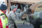 Sgt. 1st Class Justin Juliot, center, of the Nevada National Guard's 422nd Expeditionary Support Battalion, unhitches a 400-gallon water tank, commonly refereed to as a "water buffalo," to provide water for the town of Sutcliffe on Pyramid Lake Tribal land about 40 miles north of Reno, Jan. 12, 2017. The town of Sutcliffe has been without basic water services since water rushed down the western and eastern slopes of the Sierra Nevada mountain range Jan. 8, causing floods around the region and damaging fresh water pipeline to Sutcliffe.