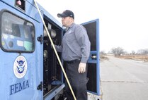 Scott McDonald, Federal Emergency Management Agency power systems support mechanic, performs inspections of massive electrical generators delivered to the Glenwood Training Area Jan. 15, 2017, Tinker Air Force Base, Oklahoma. FEMA established an Incident Support Base where emergency assets and FEMA personnel like McDonald, who lives near San Francisco, California, stage in response to the ongoing ice storm impacting the Central Plains region of the U.S. FEMA and the 72nd Air Base Wing have an agreement in place to use Tinker AFB due to its strategic location where two major interstate highways intersect along with a robust base infrastructure such as an 11,000 foot runway and cargo-handling facility. (U.S. Air Force photo/Greg L. Davis)