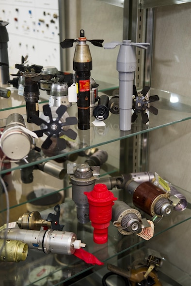 Explosive ordnance training aids sit in a display case at the 4th Civil Engineer Squadron Explosive Ordnance Disposal flight, Dec. 14, 2016, at Seymour Johnson Air Force Base, North Carolina. The EOD flight utilizes a 3-D printer to create plastic models of real training aids to be used in training exercises. (U.S. Air Force photo by Airman Shawna L. Keyes)