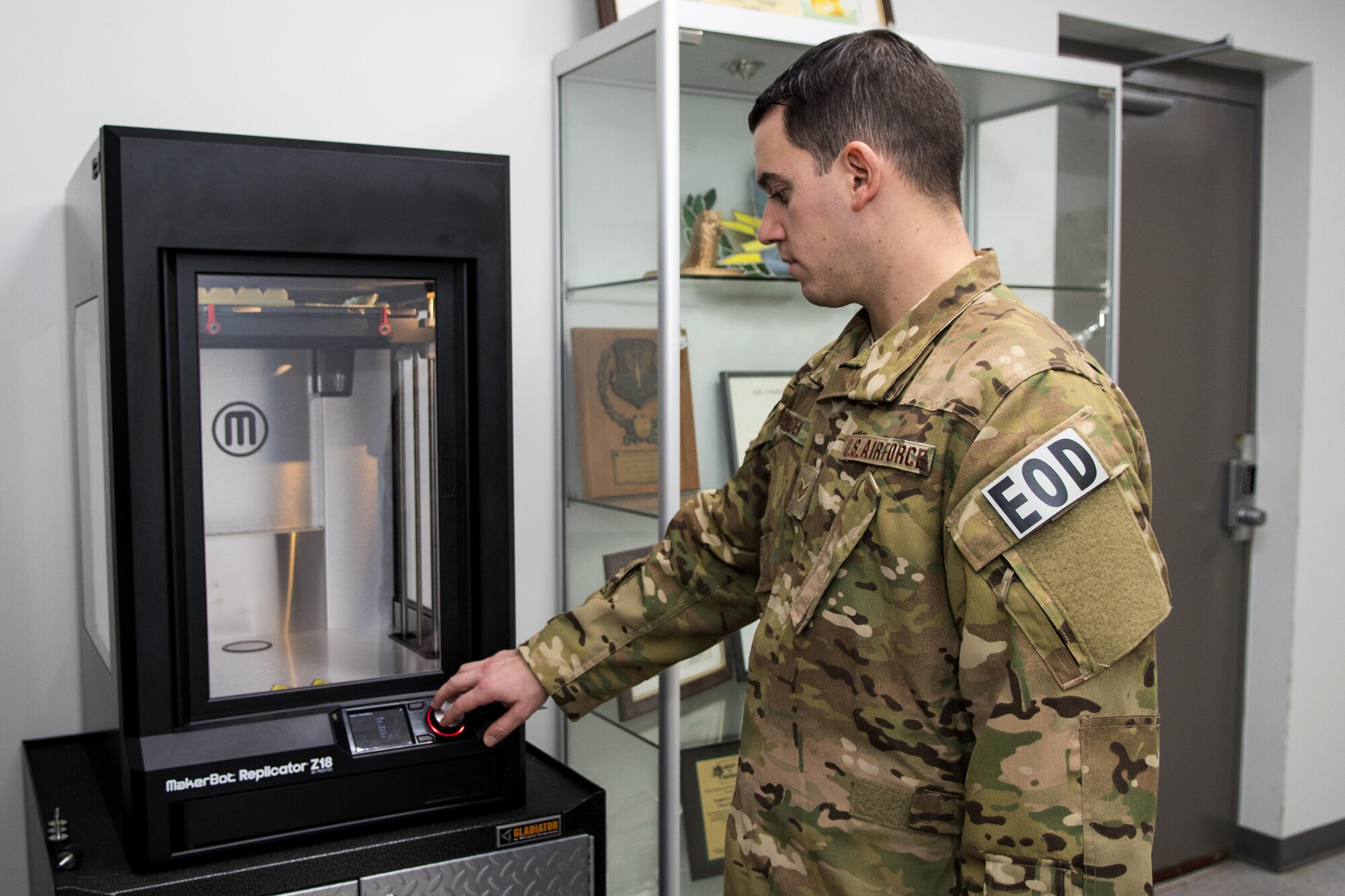 Senior Airman Nathanael Banden, 4th Civil Engineer Squadron explosive ordnance disposal technician, checks on the 3-D printer as it prints a training aid, Dec. 14, 2016, at Seymour Johnson Air Force Base, North Carolina. Printing jobs can take anywhere from 10 to more than 48 hours to complete, depending on the size and complexity of the training aid. (U.S. Air Force photo by Airman Shawna L. Keyes)