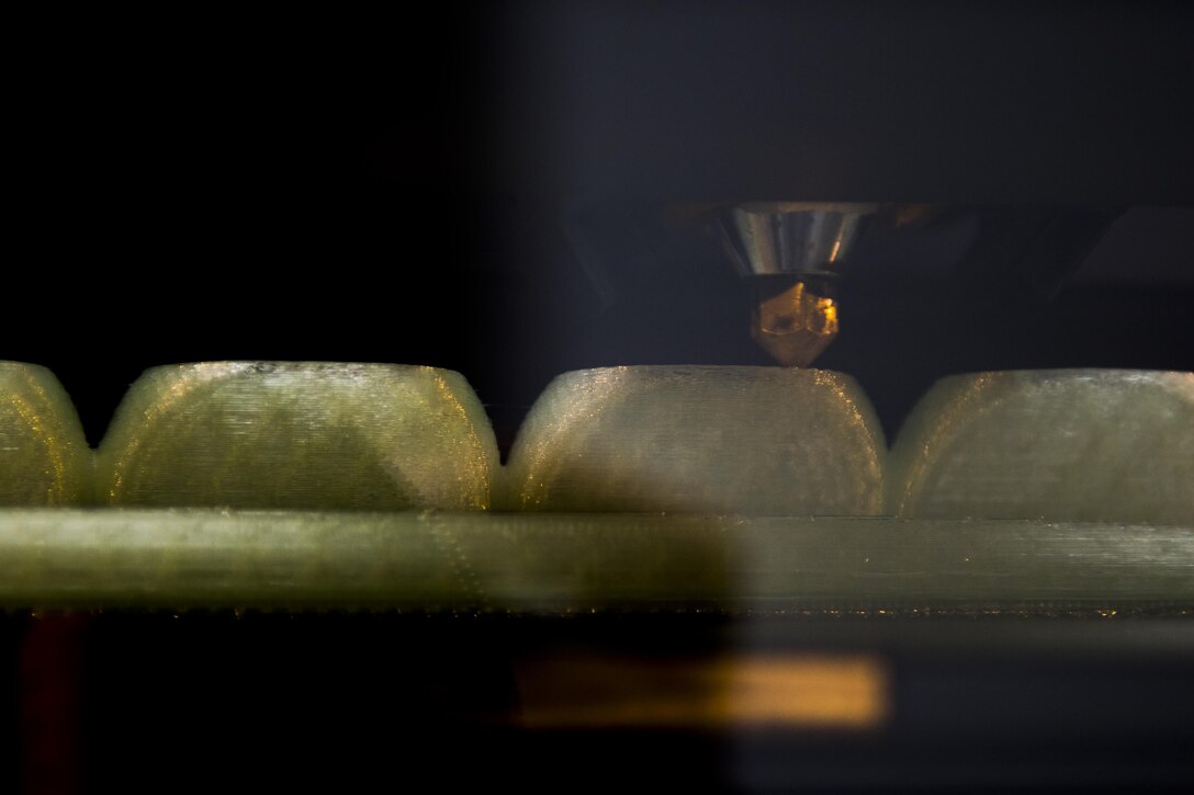 The 4th Civil Engineer Squadron Explosive Ordnance Disposal unit’s 3-D printer puts down plastic in layers to create glow-in-the-dark location markers, Dec. 14, 2016, at Seymour Johnson Air Force Base, North Carolina. The EOD flight utilizes the 3-D printer to create training aids that are approximately 90 percent less expensive than buying the real thing. (U.S. Air Force photo by Airman Shawna L. Keyes)