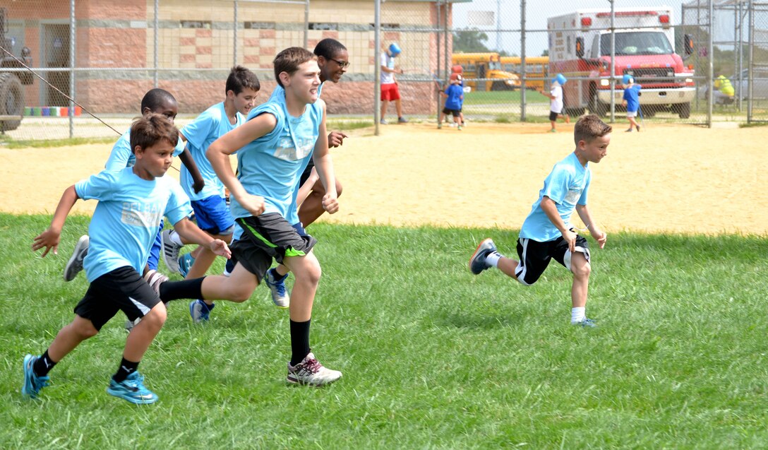 Local children complete seven obstacle courses during the Philly Play Summer Challenge August 10, 2016 in Northeast Philadelphia. DLA Troop Support active duty personnel were among nearly 40 military personnel to help more than 2,000 local children during the event, aimed at encouraging teamwork and physical fitness.