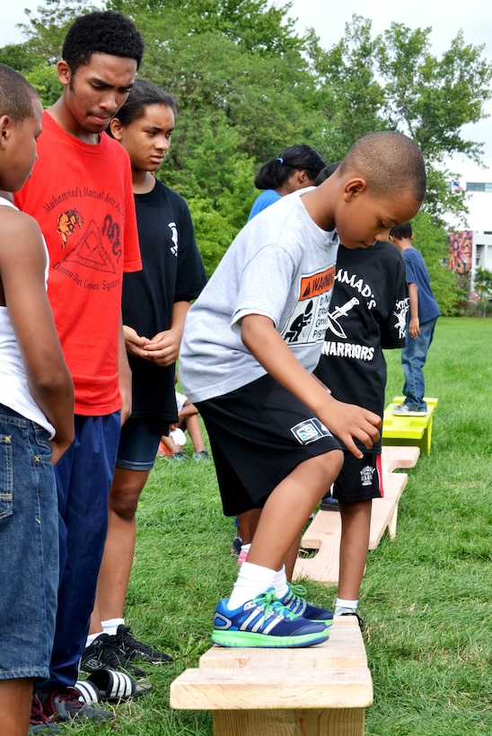 Local children complete seven obstacle courses during the Philly Play Summer Challenge August 10, 2016 in Northeast Philadelphia. DLA Troop Support active duty personnel were among nearly 40 military personnel to help more than 2,000 local children during the event, aimed at encouraging teamwork and physical fitness.