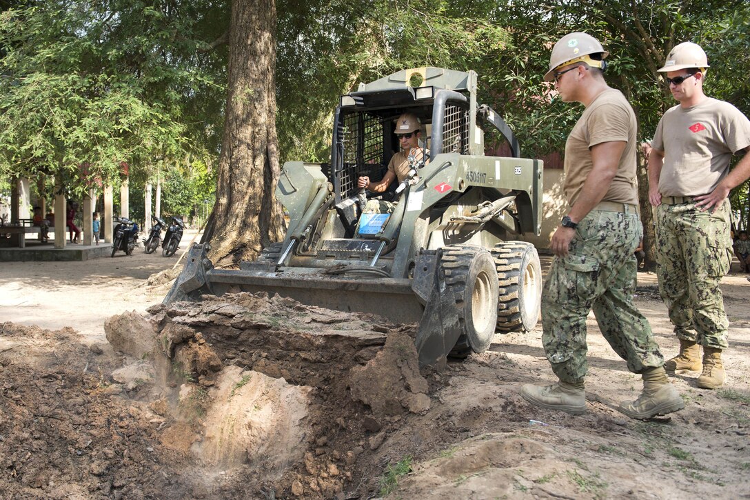 Sailors fill several holes after removing stumps from Sromo Pagoda in Svay Rieng province, Cambodia, Jan. 9, 2017. The sailors are Seabees assigned to Naval Mobile Construction Battalion 5, and provide support to major combat operations, humanitarian assistance and disaster relief operations, general engineering and civil support to Navy, Marine Corps and joint operational forces. Navy photo by Petty Officer 1st Class Benjamin A. Lewis