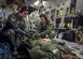 (Left) 1st Lt. Julia Lesage, a former first sergeant now flight nurse with the 315th Aeromedical Evacuation Squadron, and Senior Airman Josh Lykins, 315th AES medical technician, buckle in a simulated patient during a training mission aboard a C-17 Globemaster III en route to Ramstein Air Base Germany Jan. 13, 2016. (U.S. Air Force photo by Senior Airman Tom Brading)