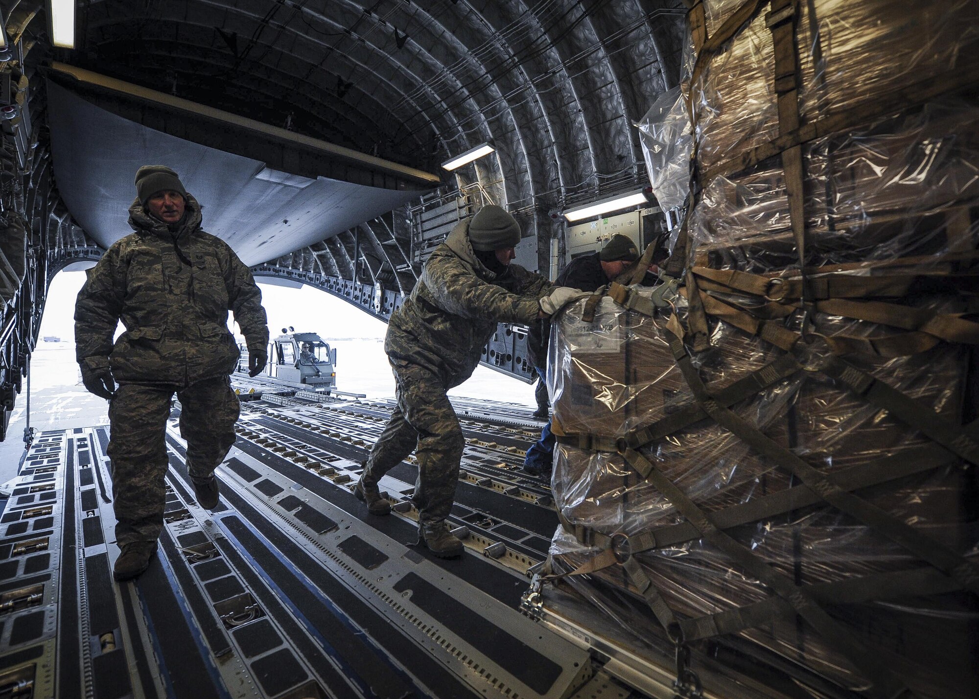 934th Airlift Wing Airmen at Minneapolis-St. Paul Air Reserve Station load humanitarian cargo onto a Joint Base Charleston C-17 Globemaster III Jan. 13, 2017. The 315th Airlift Wing flew more than 50,000 pounds of donated meals intended for refugees in northern Iraq. (U.S. Air Force photo by Senior Airman Tom Brading)