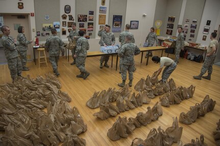 U.S. Air Force Band members volunteer to assemble bagged meals at Joint Base Anacostia-Bolling, District of Columbia, Jan. 13, 2017. During the inaugural parade rehearsal, Jan. 15, the band, Air Force Reserve, and Air Force Guard were provided approximately 300 bagged meals to eat.  (U.S. Air Force photo by Airman 1st Class Valentina Lopez)