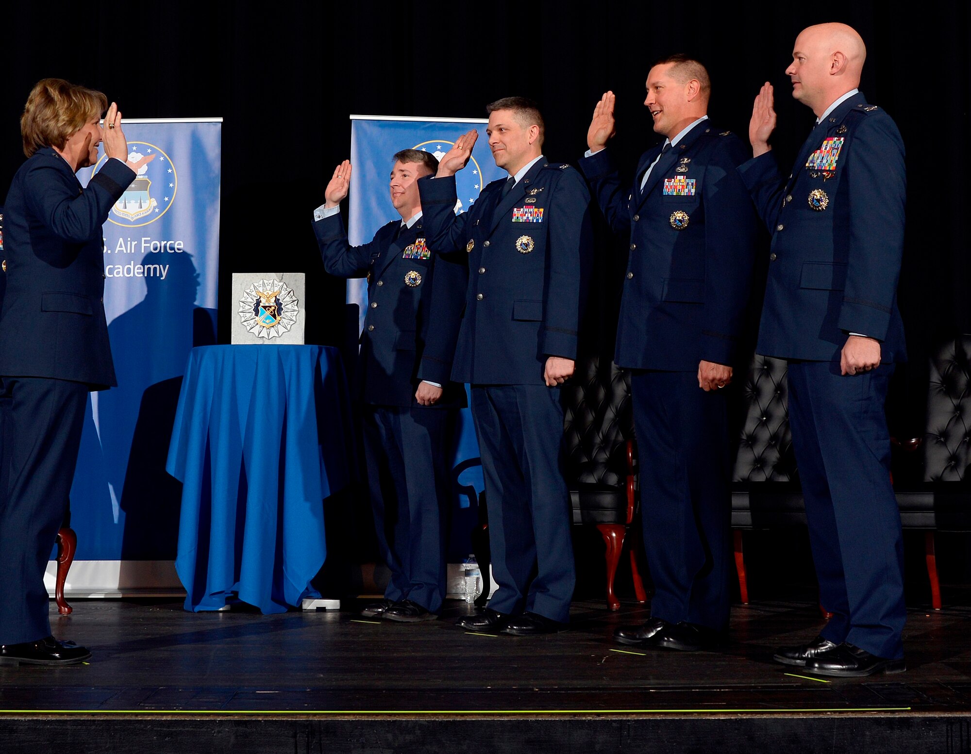 Lt. Gen. Michelle Johnson (left), the superintendent of the U.S. Air Force Academy, recognizes the Academy's four newest permanent professors at a Jan. 6, 2016 investiture ceremony in Arnold Hall. The professors are (from left to right): Col. John Cinnamon, head of the Aeronautics Department; Col. Scott Williams, head of the Mathematical Sciences Department; Col. Steven Hasstedt, head of the Biology Department; and Col. Mark Anarumo, director of the Center for Character and Leadership Development. (U.S. Air Force photo/Jason Gutierrez)