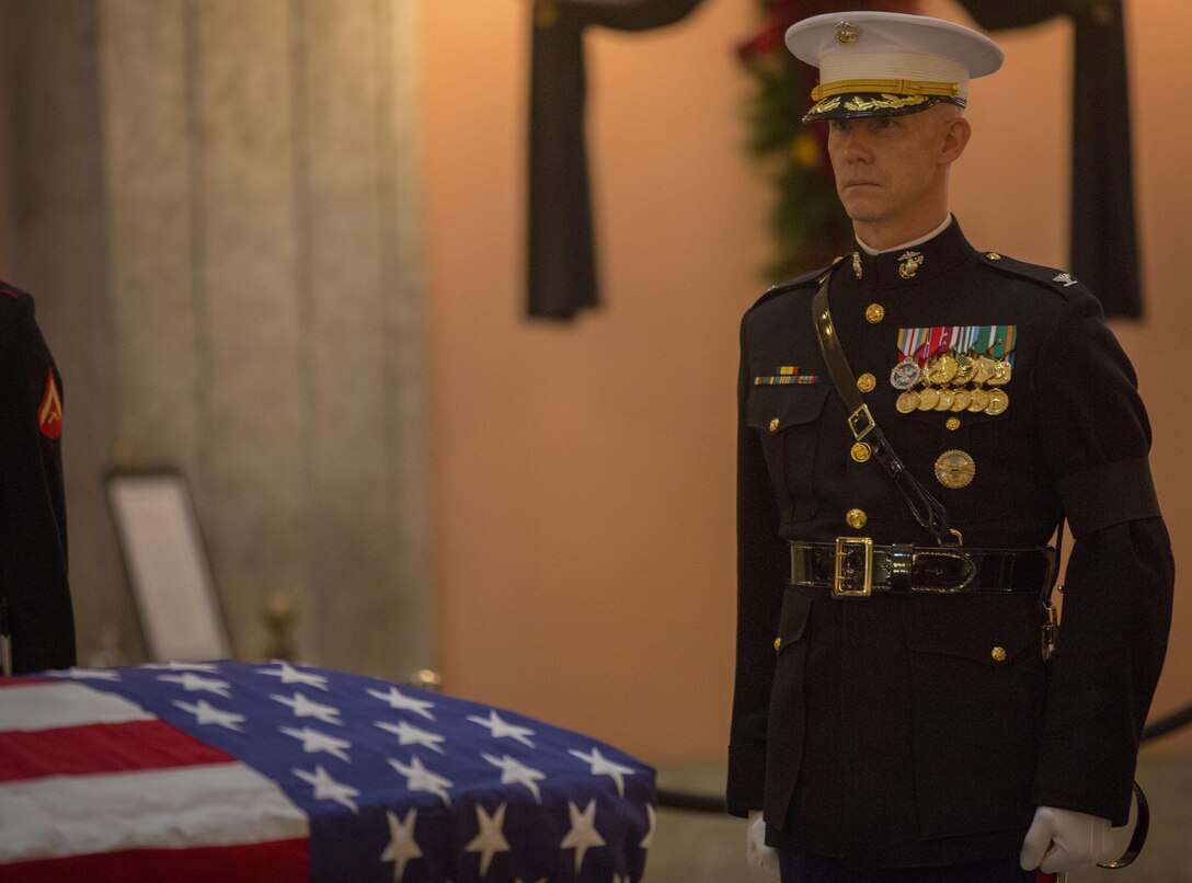 U.S. Marine Corps Col. Tyler J. Zagurzki, commanding officer, Marine Barracks Washington, stands at the position of attention in front of the casket of Sen. John H. Glenn, Jr., at the Ohio Statehouse in Columbus, Ohio, Dec. 16, 2016. Having flown 149 combat missions in World War II and the Korean War, John Glenn became the first man to orbit the earth in 1962. After retiring from the space program, Glenn was elected to the Ohio State Senate in 1974. (U.S. Marine Corps photo by Lance Cpl. Paul Ochoa/Released)
