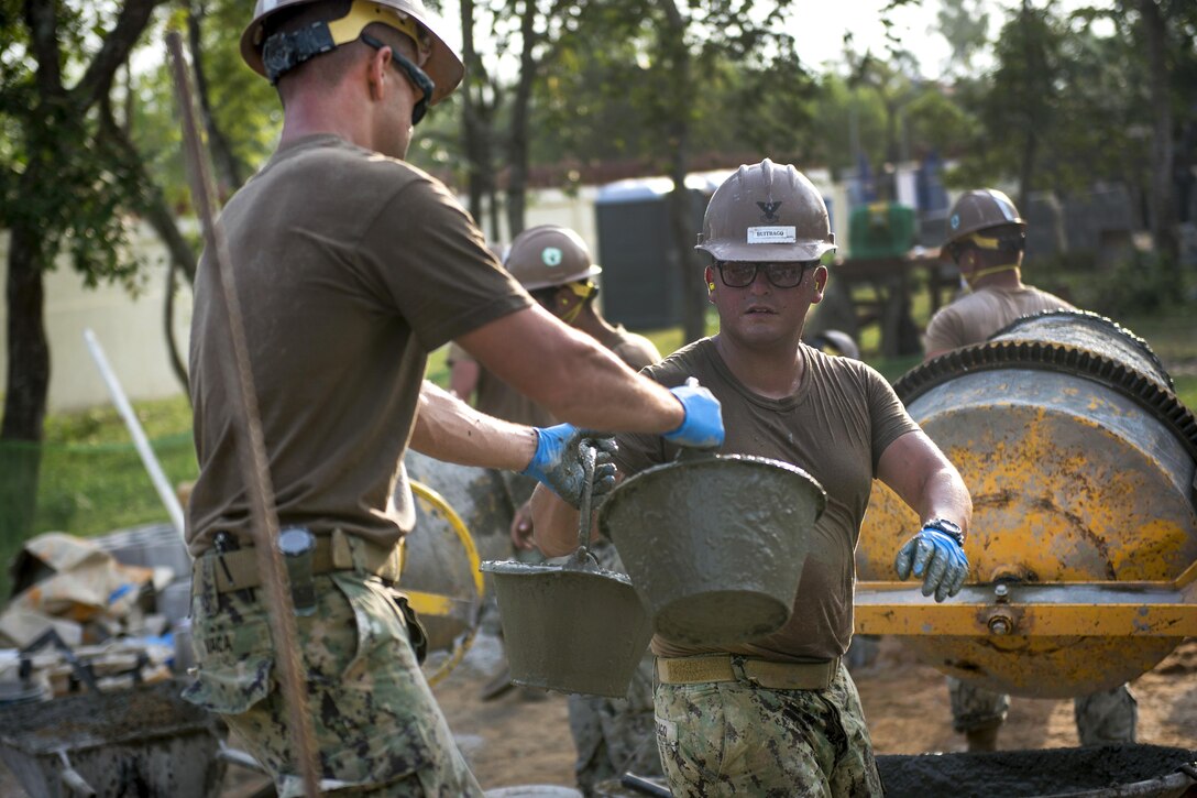 Navy Petty Officer 2nd Class Glenn Vaca, left, and Navy Petty Officer 2nd Class Jaime Buitrago help build a five-stall bathroom at the Sromo Primary School in Svay Rieng province, Cambodia, Jan. 11, 2017. Vaca is a builder constructionman and Buitrago is a builder assigned to Naval Mobile Construction Battalion 5. Navy photo by Petty Officer 1st Class Benjamin A. Lewis