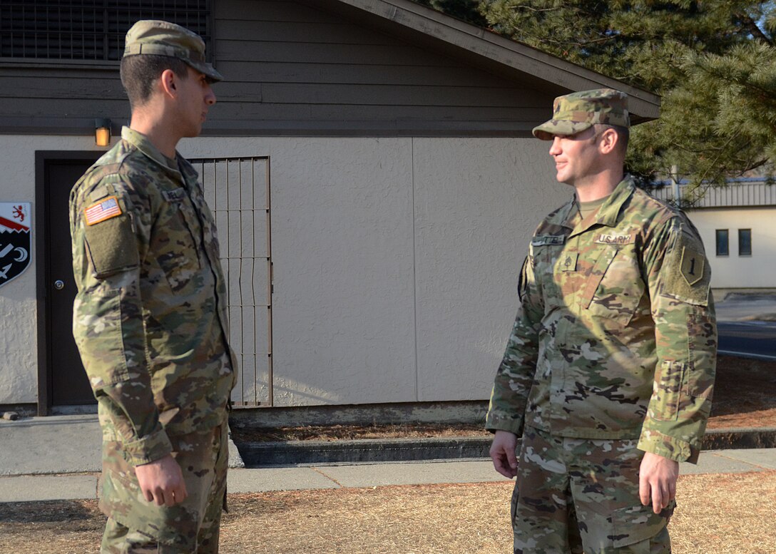 Army Staff Sgt. Stephen Littel, right, the master gunner for the 1st Engineer Battalion, 1st Armored Brigade Combat Team, 1st Infantry Division, and Army Spc. Malakki Jewell, a gunner for multilaunch rocket systems with 2nd Battalion, 18th Field Artillery Regiment, talk about Jewell’s future appearance at his battalion’s Soldier of the Month board during a visit to Camp Hovey, South Korea, Jan. 6, 2017. Littel and Jewell are father and son who are based out of different U.S. military installations and recently deployed to South Korea at the same time. Army photo by Staff Sgt. Warren W. Wright