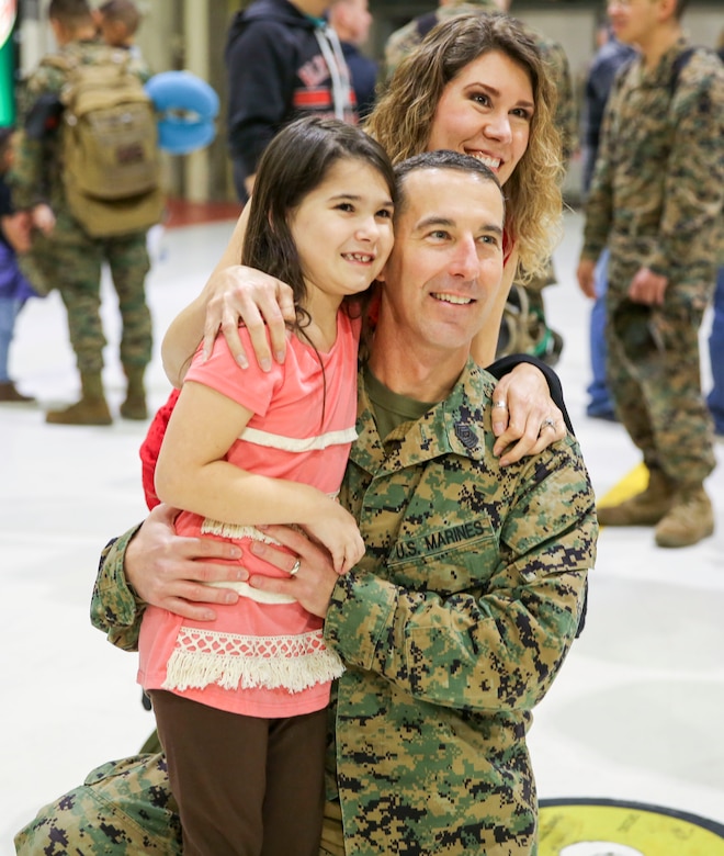 Sgt. Maj. Brandon Eckardt and his family are reunited aboard Marine Corps Air Station Cherry Point, Jan. 16, 2017 after a deployment with the 31st Marine Expeditionary Unit. Eckardt and fellow Marines assigned to Marine Attack Squadron 54, Marine Aircraft Group 14, 2nd Marine Aircraft Wing returned to MCAS Cherry Point for the first time since being deployed in June, 2016. Eckardt is the sergeant major of VMA-542. (U.S. Marine Corps photo by Lance Cpl. Cody Lemons/Released)