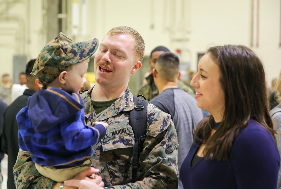 1st Lt. Zachary Williams holds his son after returning from a deployment with the 31st Marine Expeditionary Unit Jan. 16, 2017. Marines assigned to Marine Attack Squadron 542, Marine Aircraft Group 14, 2nd Marine Aircraft Wing returned to Marine Corps Air Station Cherry Point, N.C. after deploying in June, 2016. The 31st MEU is the only continuously forward-deployed MEU.  Williams is an air intelligence officer assigned to VMA-542. (U.S. Marine Corps photo by Lance Cpl. Cody Lemons/ Released)