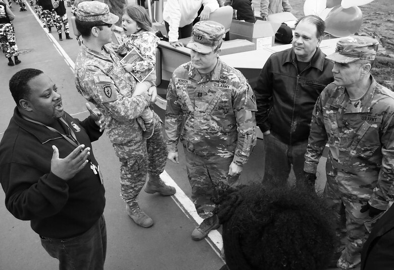 Colonel Christopher Hussin, commander, Tulsa District, U.S. Army Corps of Engineers, and district volunteers receive parade instructions from Mr. Michael Ware, African American Programs Manager,  before the beginnning of the 38th annual Martin Luther King Jr. Commemorative Parade in Tulsa, Okla., January 16, 2017.   Personnel from the Tulsa District have been participating in the city of Tulsa's MLK Day parade for more than 20 years. (U.S. Army Corps of Engineers photo by Preston Chasteen/Released)