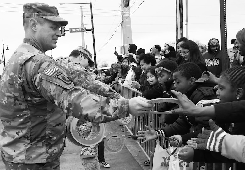 Lieutenant Colonel Dan Young, deputy commander, Tulsa District, U.S. Army Corps of Engineers, passes out frisbees as water safety reminders to children along the parade route at the 38th annual Martin Luther King Jr. Commemorative Parade in Tulsa, Okla., January 16, 2017.   Personnel from the Tulsa District have been participating in the city of Tulsa's MLK Day parade for more than 20 years. (U.S. Army Corps of Engineers photo by Preston Chasteen/Released)