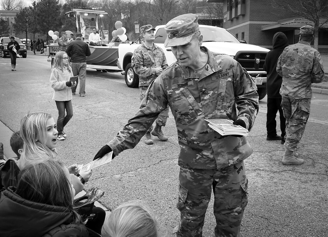 Colonel Christopher Hussin, commander, Tulsa District, U.S. Army Corps of Engineers, passes out coloring books as water safety reminders to children along the parade route during the 38th annual Martin Luther King Jr. Commemorative Parade in Tulsa, Okla., January 16, 2017.   Personnel from the Tulsa District have been participating in the city of Tulsa's MLK Day parade for more than 20 years. (U.S. Army Corps of Engineers photo by Preston Chasteen/Released)