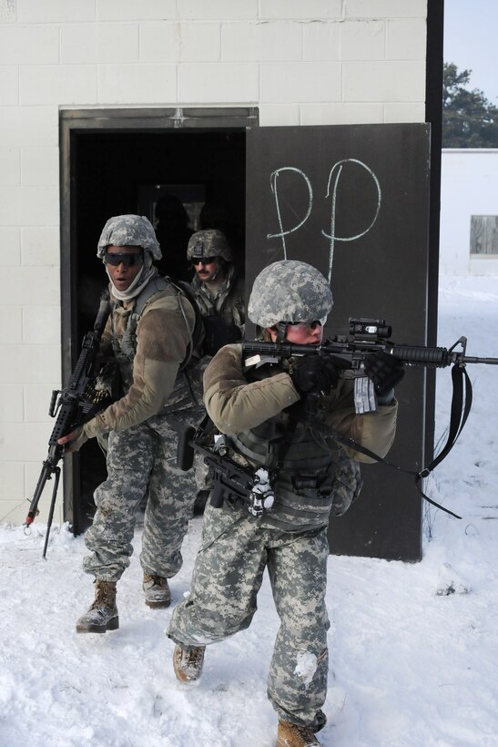 New Jersey Army National Guardsmen exit a building during a training exercise at Joint Base McGuire-Dix-Lakehurst, N.J., Jan. 9, 2017. Army National Guard photo by Sgt. 1st Class Wayne Woolley
