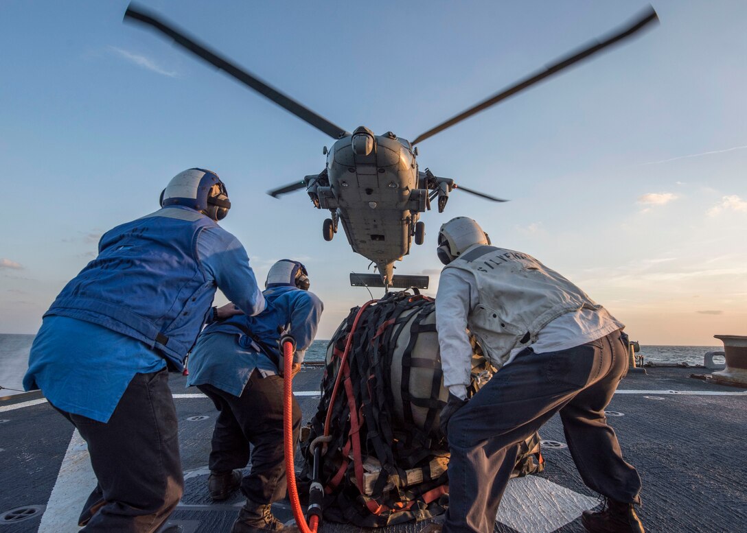170114-N-CS953-010
ARABIAN SEA (Jan. 14, 2017) Sailors aboard the Arleigh Burke-class guided-missile destroyer USS Mahan (DDG 72) prepare to attach cargo to a helicopter from Helicopter Sea Combat Squadron (HSC) 26 during a vertical replenishment. Mahan is deployed in the U.S. 5th Fleet area of operations in support of maritime security, and theater security operation efforts. (U.S. Navy photo by Mass Communication Specialist 1st Class Tim Comerford/Released)
