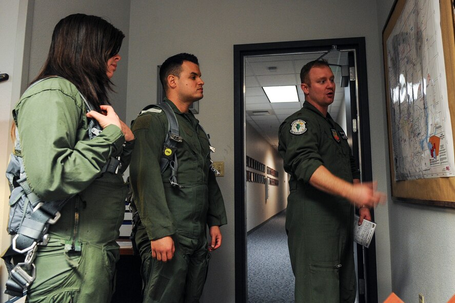 Maj. Cody Clark, 433rd Weapons Squadron F-15 Eagle pilot, briefs Senior Airman Sierra Elliott, 57th Maintenance Squadron munitions specialist, and Staff Sgt. Gabriel Gamboa, 57th Aircraft Maintenance Squadron training monitor, before an incentive flight at Nellis Air Force Base, Nev., Jan. 6, 2017. Before Elliott and Gamboa’s flights, Clark talked about flight procedures and where they would be flying.