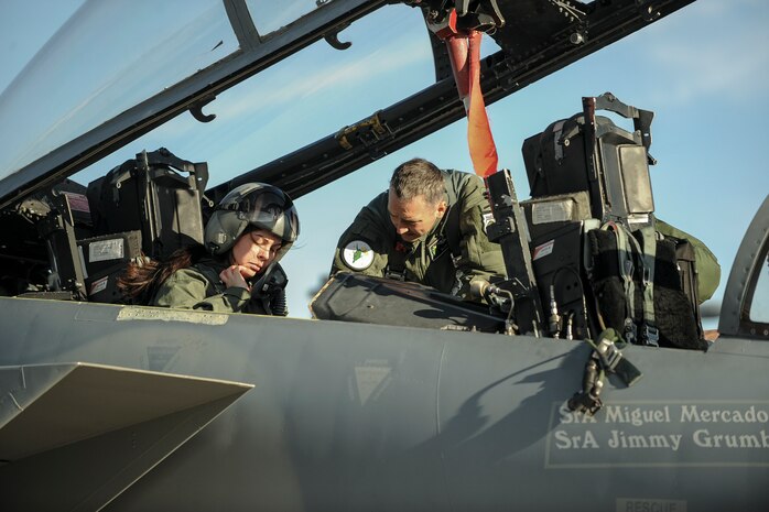 Capt. Josh Hovanas, 433rd Weapons Squadron F-15 Eagle pilot, helps Senior Airman Sierra Elliott, 57th Maintenance Squadron munitions specialist, prepare for flight during the 57th Wing’s annual incentive fly day at Nellis Air Force Base, Nev., Jan. 6, 2017. Pilots from the 16th WPS, 17th WPS, 433rd WPS, 422nd Test and Evaluation Squadron, and the Thunderbirds flew the incentive flyers and met with them beforehand to give them an idea of what to expect during flight.