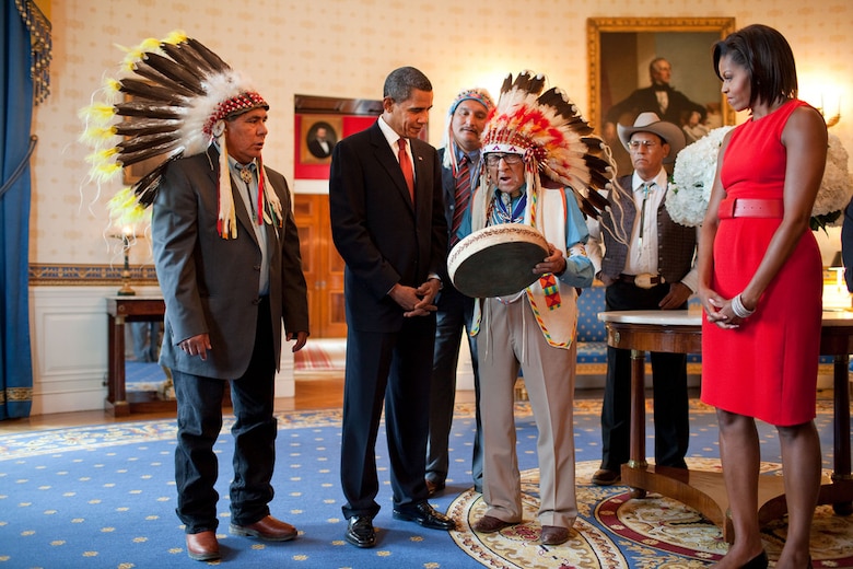 Presidential Medal of Freedom recipient Joseph Medicine Crow shows a drum to President Barack Obama and First Lady Michelle Obama during a reception for recipients and their families in the Blue Room of the White House on Aug. 12, 2009. (Official White House photo by Pete Souza) P081209PS-0965