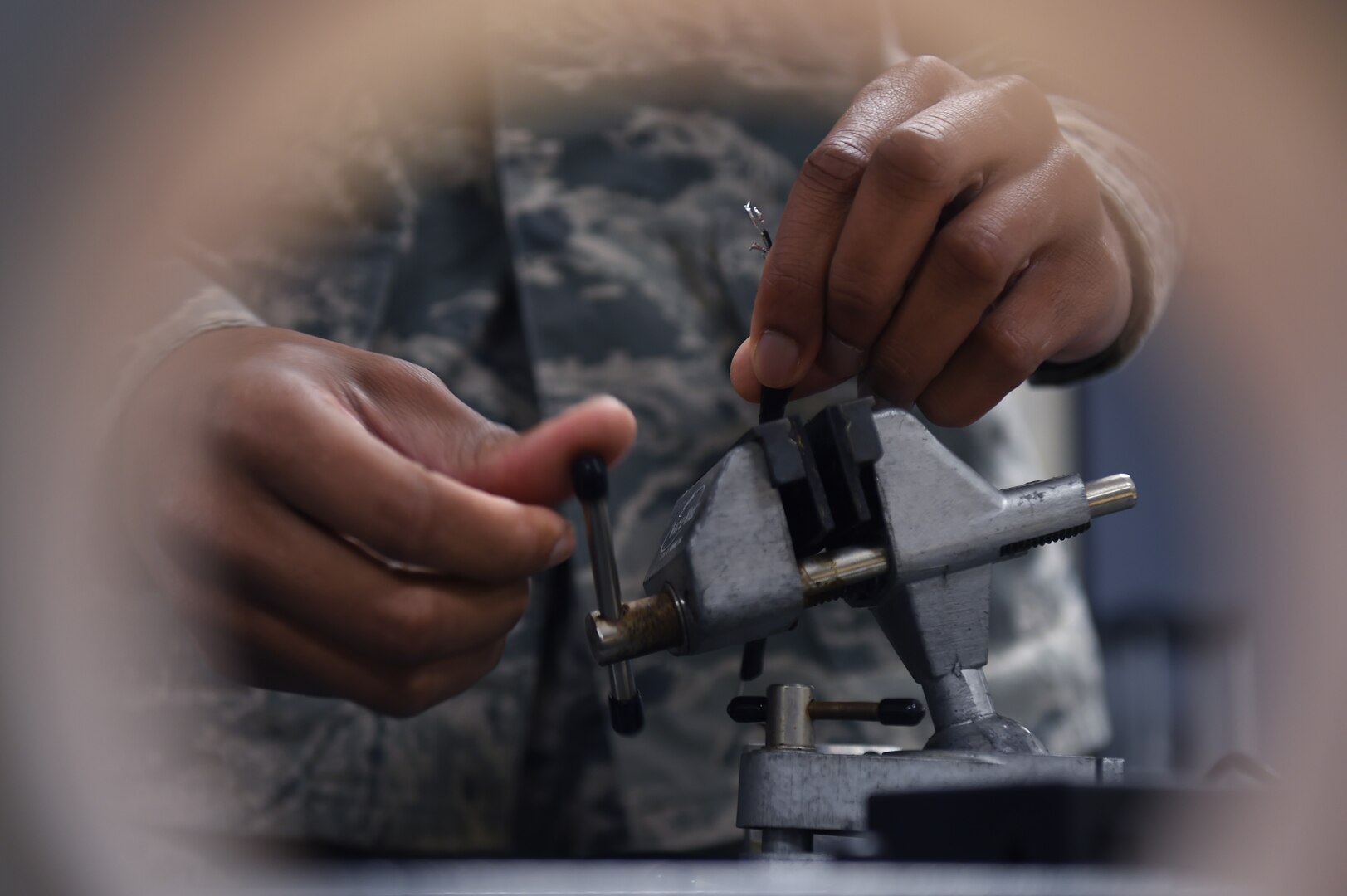 Senior Airman Donnell Johnson, 59th Medical Logistics and Readiness Squadron biomedical equipment technician, uses a vise to hold a load cell wire in place Nov. 18 at the Wilford Hall Ambulatory Surgical Center on Joint Base San Antonio-Lackland. The 59th MLRS helps the 59th Medical Wing deliver quality health care to patients by providing the organization with best-value materiel, services, transportation, equipment and facilities in a safe and secure environment. (U.S. Air Force photo/Staff Sgt. Jason Huddleston)