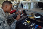 Senior Airman Donnell Johnson, 59th Medical Logistics and Readiness Squadron biomedical equipment technician, uses a multimeter to check voltage on a circuit board during a service call Nov. 17 at the U.S. Air Force Post Graduate Dental School on Joint Base San Antonio-Lackland, Texas. A biomedical equipment technician ensures medical equipment is serviceable, safe and properly configured to meet the wartime and peacetime missions of the Air Force Medical Service. (U.S. Air Force photo/Staff Sgt. Jason Huddleston)