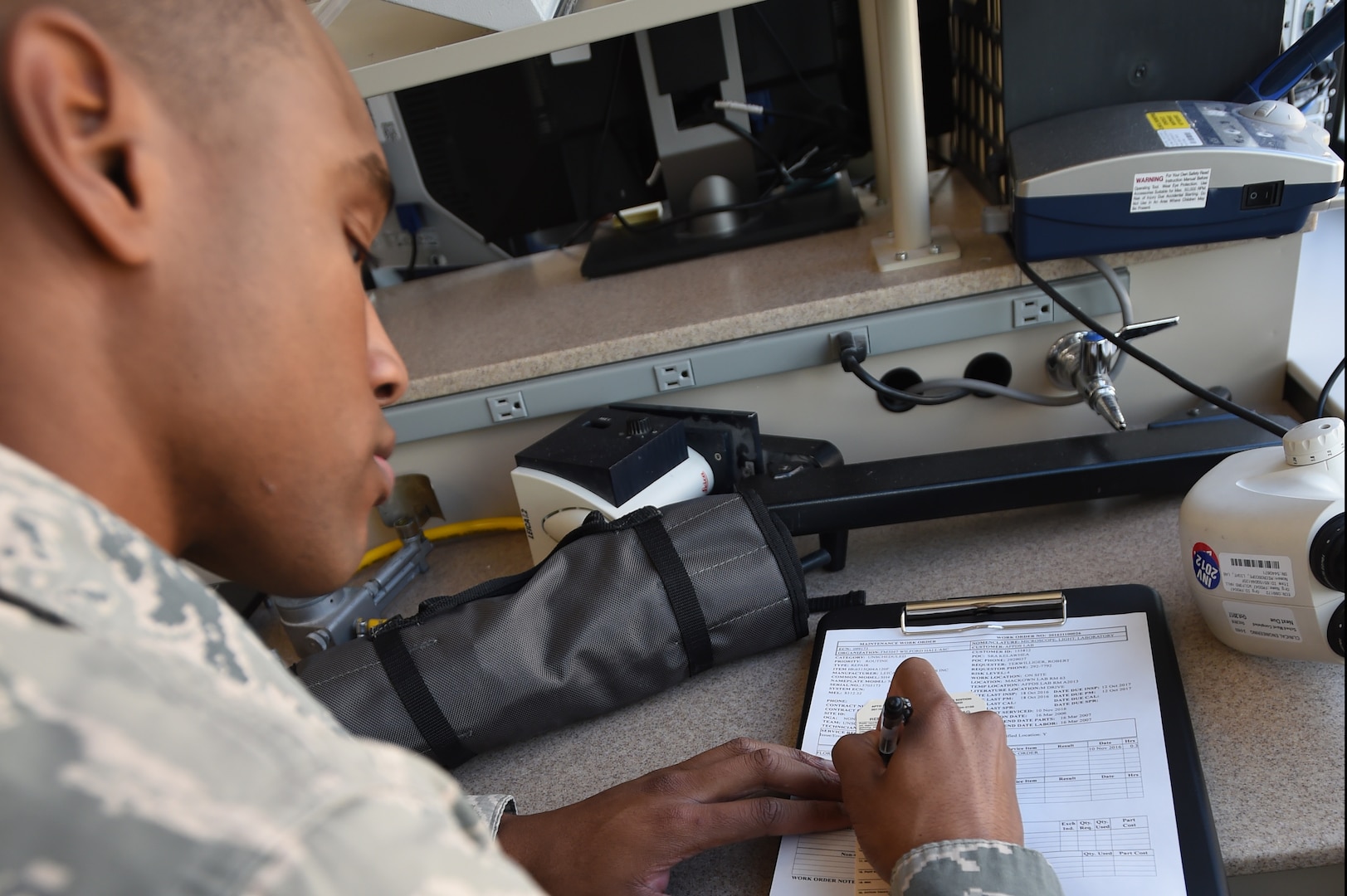 Senior Airman Donnell Johnson, 59th Medical Logistics and Readiness Squadron biomedical equipment technician, documents a service call Nov. 17 at the U.S. Air Force Post Graduate Dental School on Joint Base San Antonio-Lackland, Texas. Biomedical equipment technicians enable the 59th Medical Wing to provide world-class patient care to active-duty members, dependents, retirees and their families. (U.S. Air Force photo/Staff Sgt. Jason Huddleston)