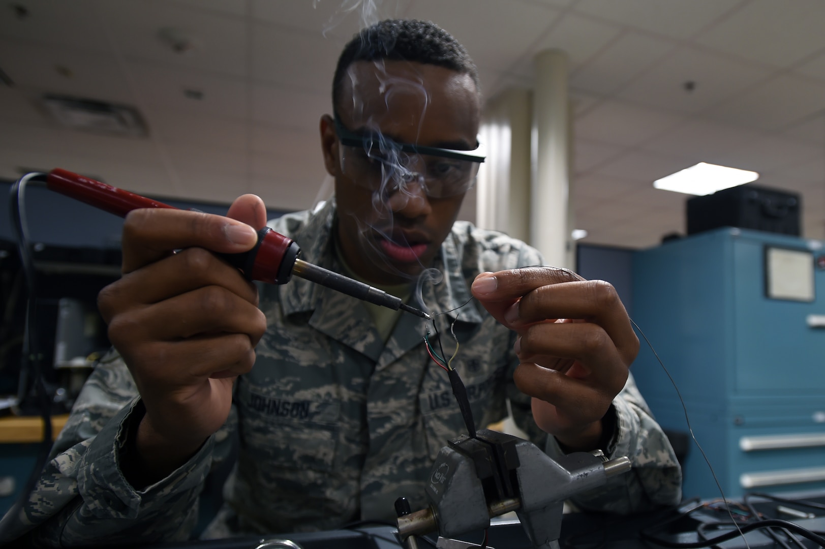 Senior Airman Donnell Johnson, 59th Medical Logistics and Readiness Squadron biomedical equipment technician, solders load cell wires Nov. 17 at the Wilford Hall Ambulatory Surgical Center on Joint Base San Antonio-Lackland, Texas. Load cells are used in electronic scales to measure weight and display the weight digitally. (U.S. Air Force photo/Staff Sgt. Jason Huddleston)