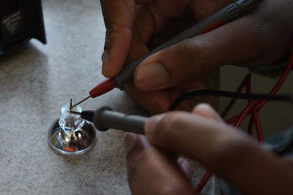 Senior Airman Donnell Johnson, 59th Medical Logistics and Readiness Squadron biomedical equipment technician, uses a multimeter to measure the resistance of a bulb Nov. 17 at the U.S. Air Force Post Graduate Dental School on Joint Base San Antonio-Lackland, Texas. Biomedical equipment technicians install, inspect, calibrate and repair medical equipment and support systems. (U.S. Air Force photo/Staff Sgt. Jason Huddleston)