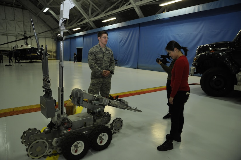 Senior Airman Joshua Holbrook, 11th Civil Engineer Squadron explosive ordnance disposal team member, explains the operating procedures of a F6A EOD robot to members of the media during media day at Joint Base Andrews, Md. Jan. 13, 2017. Holbrook, who has been working as an EOD member for three years, expressed pride in his position by stating that he would never want to do anything else and that EOD is his dream job. (U.S. Air Force Photo by Staff Sgt. Stephanie Morris)