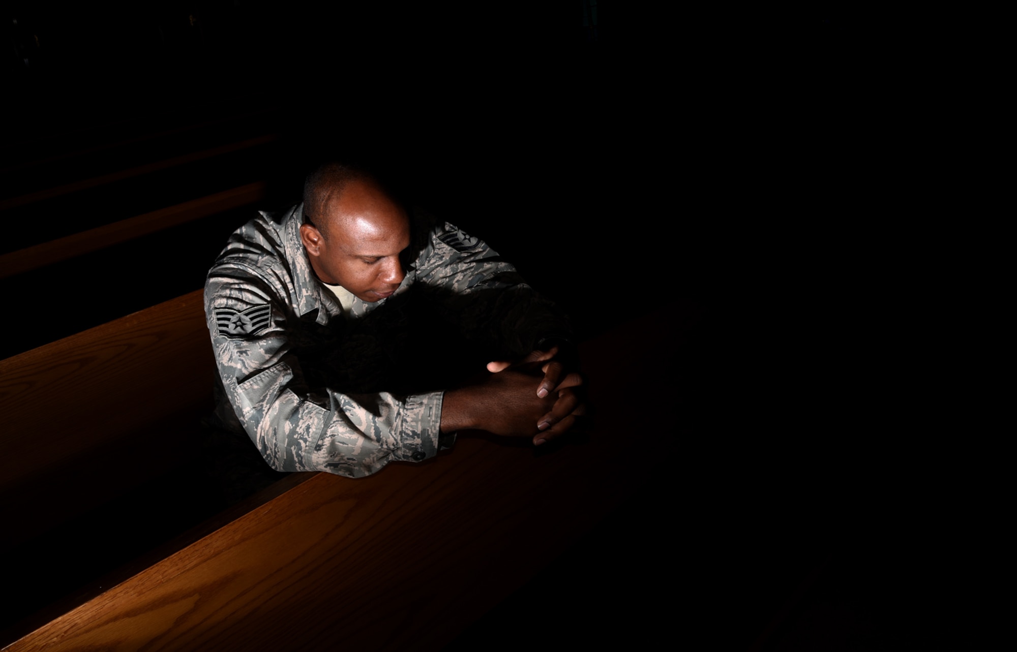 Staff Sgt. Anthony Bean, 21st Space Wing chaplain assistant, takes time during his day to pray in the sanctuary of the Base Chapel at Peterson Air Force Base, Colorado, Aug. 8, 2016. (U.S. Air Force photo by Airman 1st Class Dennis Hoffman)