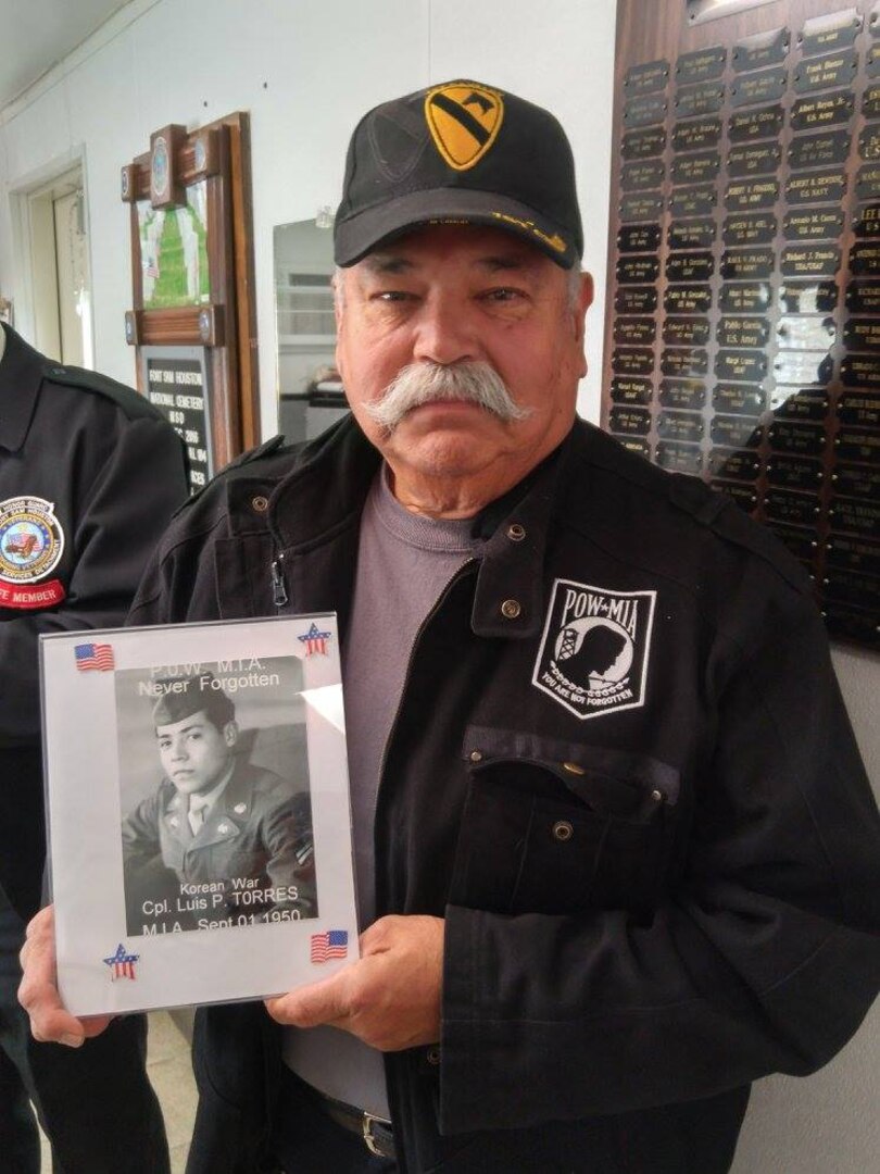 Gregorio Torres, a Vietnam veteran, poses with a photograph of his brother, Cpl. Luis Patlan Torres, who went missing in action during his tour in Korea in 1950. After 1950, Torres was determined to be a prisoner of war, and in 1954 was declared dead by the Department of Defense. His remains were unidentified until the DOD identified him through bone records. He was buried at Fort Sam Houston National Cemetery Jan. 13.