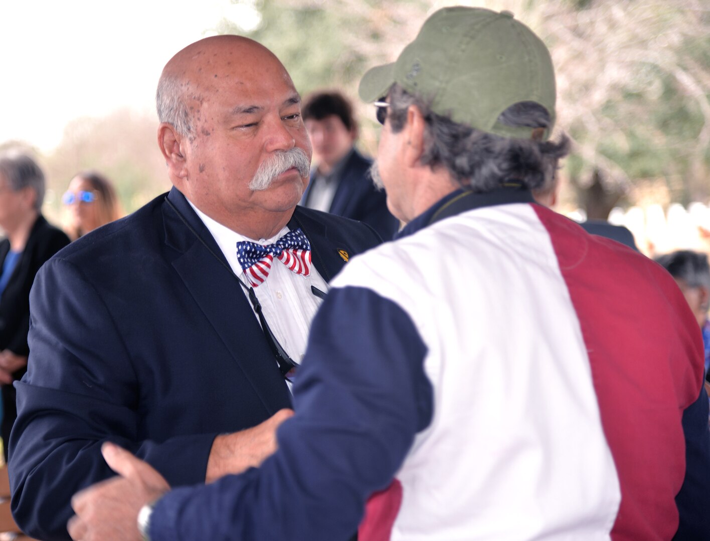 Gregorio Patlan Torres (left), the brother of Cpl. Luis Patlan Torres, who was interred at Fort Sam Houston National Cemetery Jan. 13 after being missing in action since 1950, greets fellow Fort Sam Houston Memorial Services Detachment Honor Guard member Johnny Hubbs. Gregorio, now 71, is a Vietnam War veteran.