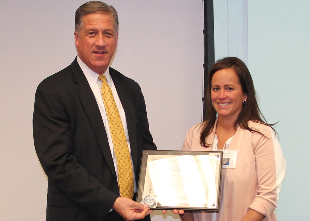 Defense Acquisition Career Manager Robert Daugherty presents DLA’s Rebecca Sims the DACM Award for Outstanding Achievement in Travel Management, Jan. 10, 2017, Fort Belvoir, Virginia.

