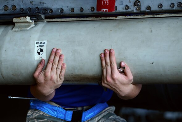 U.S. Air Force Senior Airman Brandon Atwell, 20th Aircraft Maintenance Squadron weapons load crew member, shakes an AGM-88 high-speed anti-radiation missile loaded onto an F-16CM Fighting Falcon at Shaw Air Force Base, S.C., Jan. 13, 2017. By shaking the munition, Atwell ensures the munition is properly attached on its rail. (U.S. Air Force photo by Airman 1st Class Kathryn R.C. Reaves)