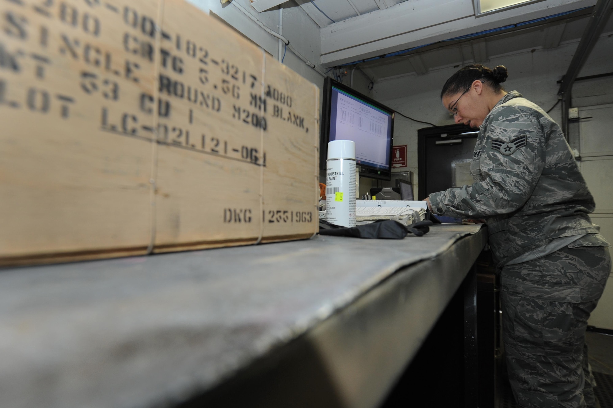 U.S. Air Force Senior Airman Angela Barbour, 19th Maintenance Squadron inspector technician, reviews a checklist before inspecting an ammunition crate for distribution Dec. 14, 2016, at Little Rock Air Force Base, Ark. The munitions flight members complete a variety of different tasks ranging from storing ammunition to inspecting munitions. (U.S. Air Force photo by Airman 1st Class Grace Nichols)