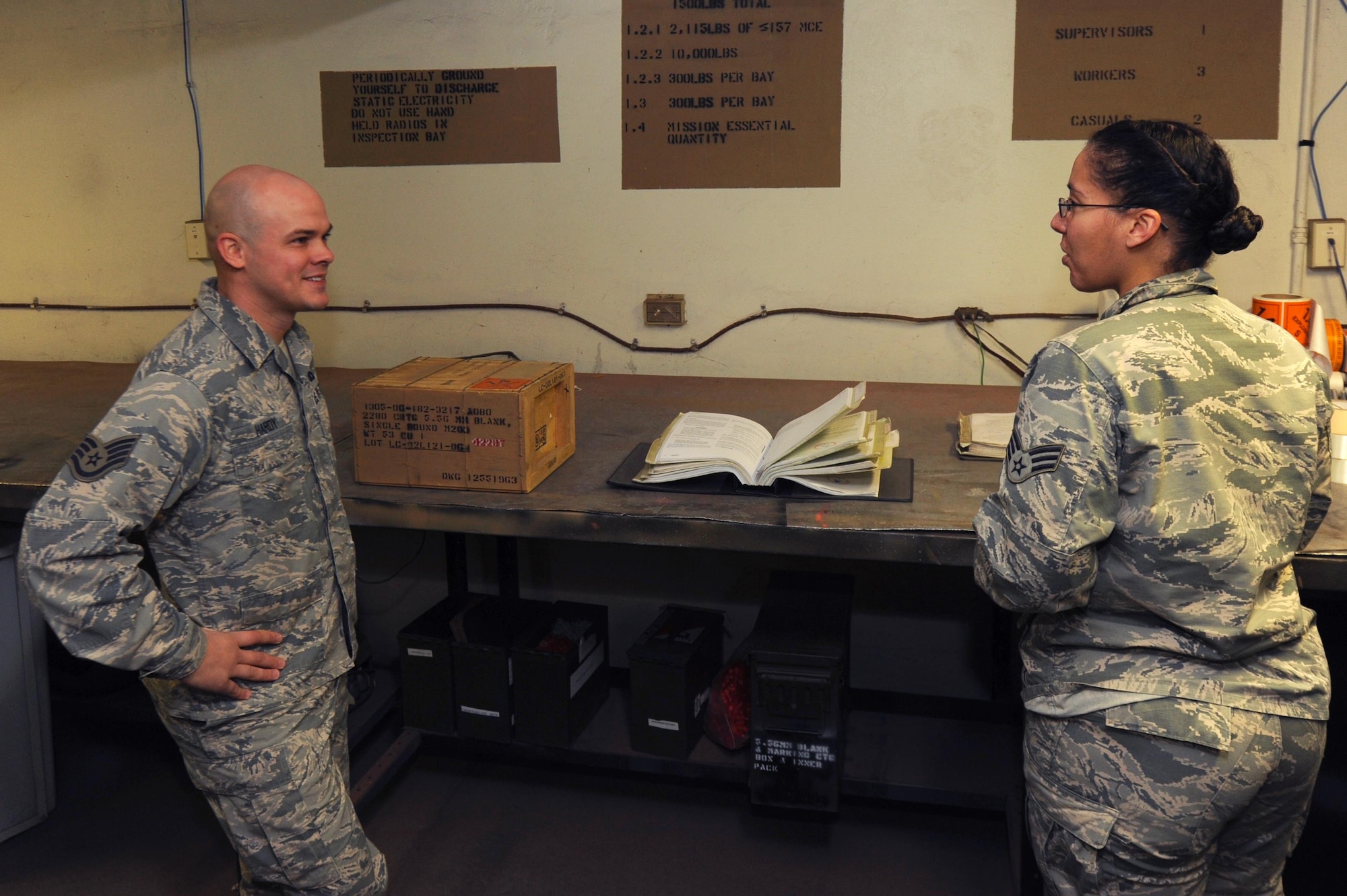 (From right) U.S. Air Force Senior Airman Angela Barbour, 19th Maintenance Squadron inspector technician, goes over a checklist prior to issuing ammunition to U.S. Air Force Staff Sgt. Charles Hardy, 19th Airlift Wing Security Forces defender, Dec. 14, 2016 at Little Rock Air Force Base, Ark. The munitions flight has the only DOD munitions storage area in the region." (U.S. Air Force photo by Airman 1st Class Grace Nichols)