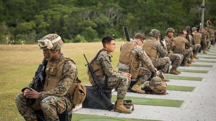 Marines from various units within Okinawa prepare for their turn to fire the table two portion of the annual rifle range qualification, Jan. 12, 2017, at Camp Hansen, Okinawa, Japan.  The Marine Corps revised table two of the marksmanship program October 2016 to increase marksmanship skill and realism in a combat environment. The Corps requires Marines to annually qualify at the range to determine their marksmanship skill. 