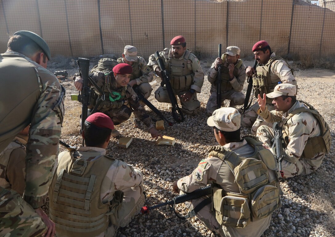 An Iraqi squad leader explains the squad movement tactics during assault movement training at Al Asad Air Base, Iraq, Jan. 13, 2017. Training at building-partner-capacity sites is an integral part of Combined Joint Task Force Operation Inherent Resolve’s effort to train Iraqi security forces personnel to defeat the Islamic State of Iraq and the Levant. Army photo by Sgt. Lisa Soy
