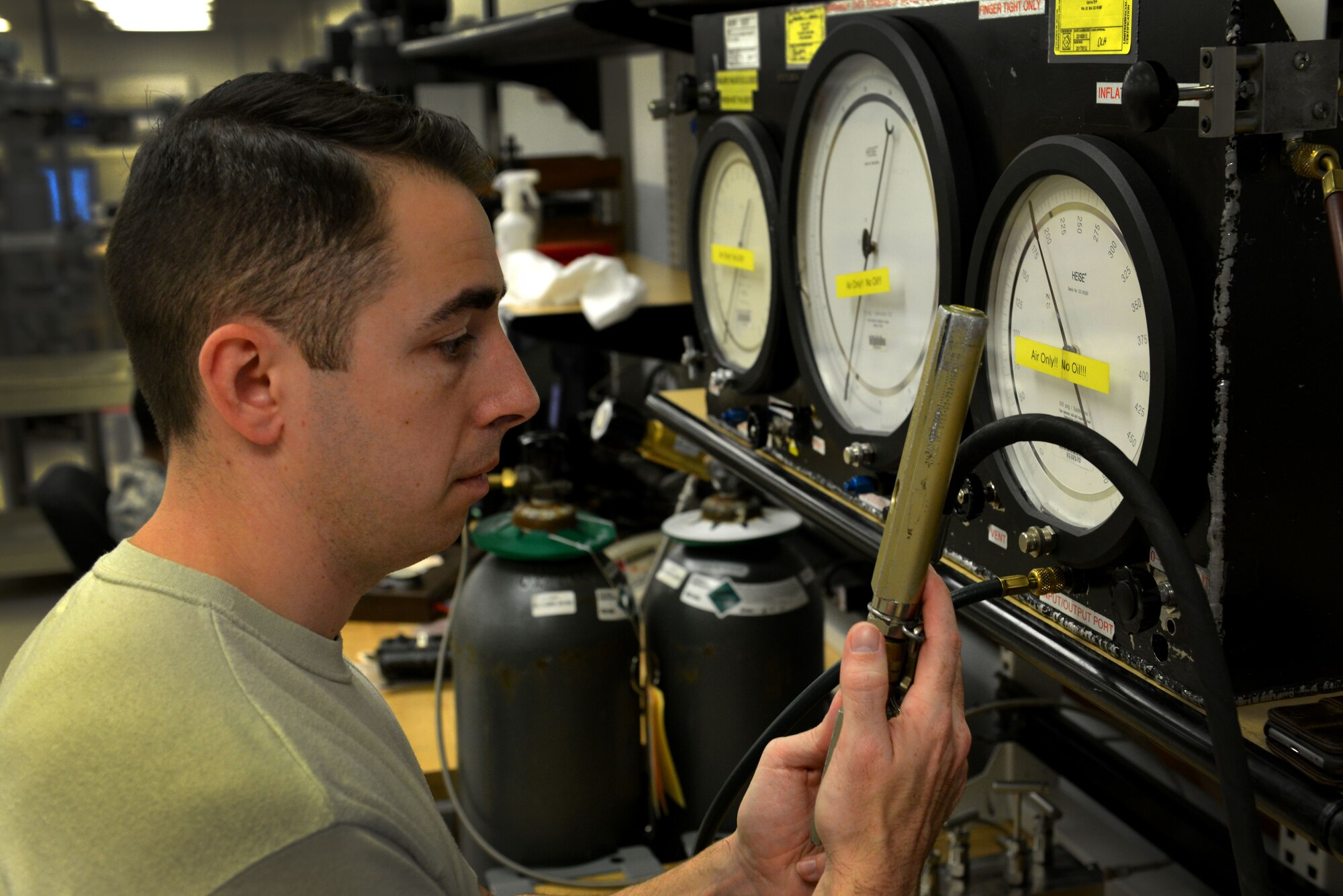 U.S. Air Force Staff Sgt. Joseph Gerdes, 20th Component Maintenance Squadron precision measurement equipment laboratory craftsman, compares the readings of two gauges at Shaw Air Force Base, S.C., Dec. 22, 2016. PMEL Airmen use gauges from their shop to test other equipment for accuracy. (U.S. Air Force photo by Airman 1st Class Destinee Sweeney)