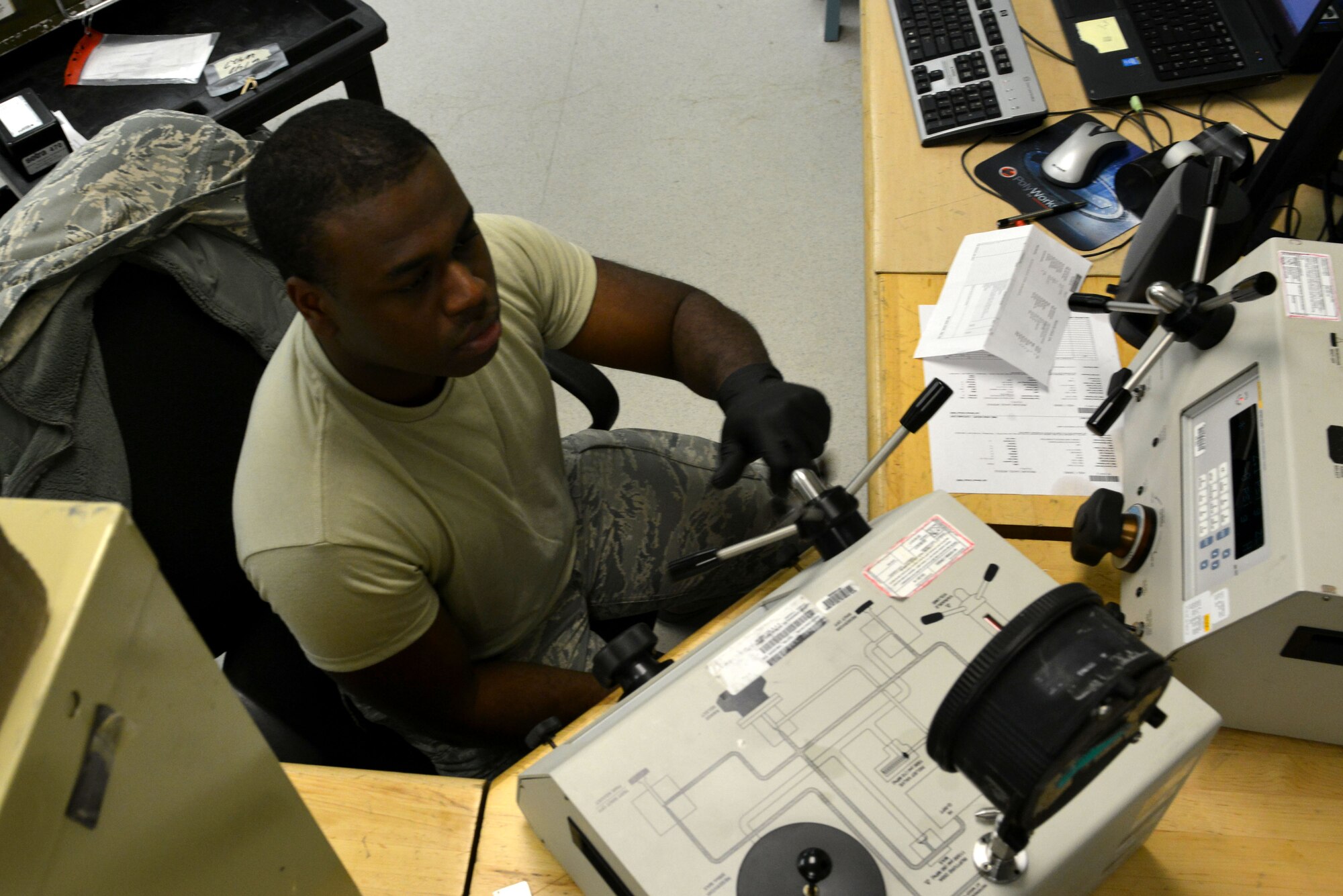 U.S. Air Force Senior Airman Tyrell Collins, 20th Component Maintenance Squadron precision measurement equipment laboratory journeyman, calibrates a pressure gauge at Shaw Air Force Base, S.C., Dec. 22, 2016. The PMEL flight maintains equipment for approximately 193 regional work centers, including nine active-duty bases, three Air National Guard bases and the Department of Homeland Security. (U.S. Air Force photo by Airman 1st Class Destinee Sweeney)