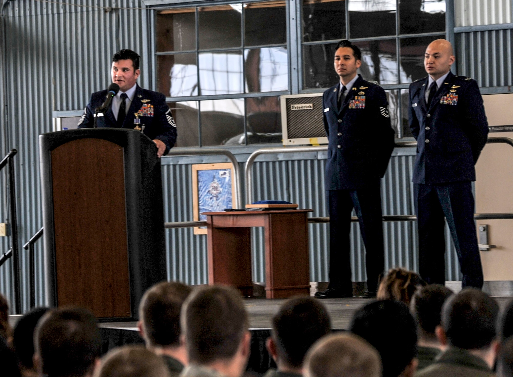 Master Sgt. Gregory Gibbs, 512th Rescue Squadron operations superintendent, addresses the audience during the Distinguished Flying Cross medal presentation at Kirtland Air Force Base, New Mexico, Jan. 13. Gibbs and his team rescued three soldiers from an active minefield at the Pakistani border. Gibbs attributed the success of the mission to basic fundamentals that he learned while in training on Kirtland. 