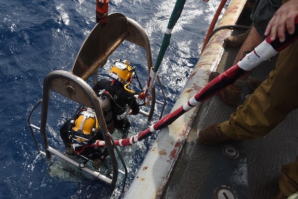 U.S. Navy Divers of Mobile Diving and Salvage Unit 2 prepare to lower the stage to conduct an underwater recovery operation in the Tyrrhenian Sea, Italy, Oct. 6, 2016. Capt. Marco Catanese, a manpower determinants flight commander with the Air Force Manpower Analysis Agency at Joint Base San Antonio-Randolph, Texas, used his training from the Language Enabled Airman Program at the Air Force Culture and Language Center recently to assist the Defense POW/MIA Accounting Agency and Italian Coast Guard in a search off the Italian coast. (U.S. Army photo/Spc. Lloyd Villanueva)