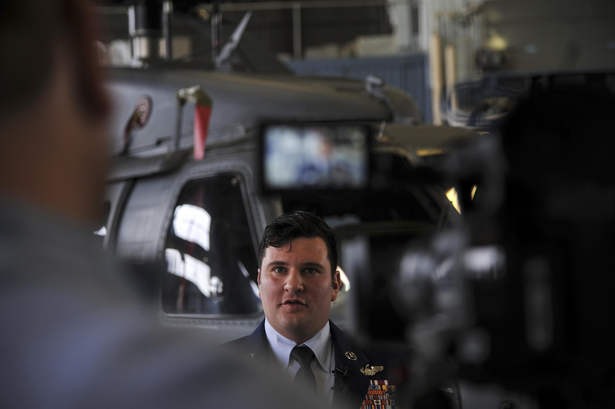Master Sgt. Gregory Gibbs, 512th Rescue Squadron operations superintendent, interviews with local media outlets during the Distinguished Flying Cross medal ceremony at Kirtland Air Force Base, New Mexico, Jan. 13. Gibbs received the medal for his quick decision making that saved the lives of nine personnel during a 2011 tour of Afghanistan. (U.S. Air Force photo by Senior Airman Nigel Sandridge)
