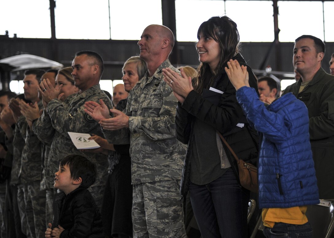 Family and friends applaud during the Distinguished Flying Cross medal ceremony at Kirtland Air Force Base, New Mexico, Jan. 13. The medal was awarded to MSgt. Gregory Gibbs, 512th Rescue Squadron operations superintendent, whose split decision making skills during a 2011 rescue mission in Afghanistan saved not only the three soldiers trapped, but the crew flying Pedro 55. (U.S. Air Force photo by Senior Airman Nigel Sandridge)