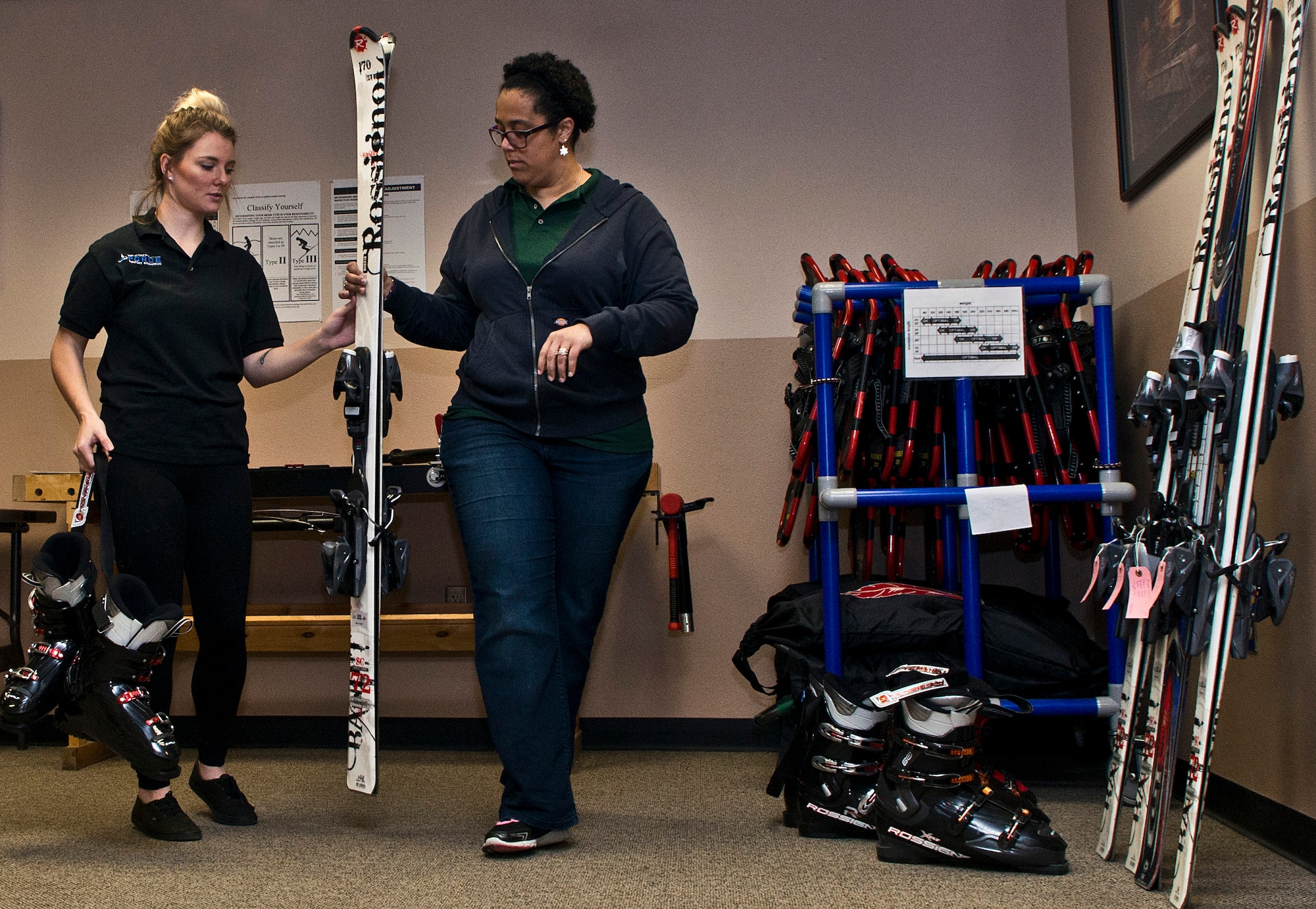 (From left) Ashley Shafer, 5th Force Support Squadron Outdoor Recreation aid, and Dana Sharrit, 5 FSS Outdoor Recreation associate, finish calibrating skis at Minot Air Force Base, N.D., Dec. 2, 2016. Outdoor Rec. is an organization that gives Airmen and their families the opportunity to experience North Dakota events like skiing, snowboarding and dog sledding. (U.S. Air Force photo/Airman 1st Class Jonathan McElderry)